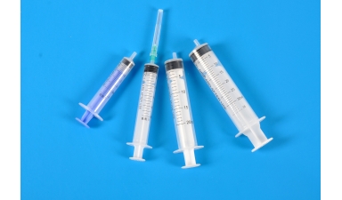 Sterile low frictional force syringes for single use